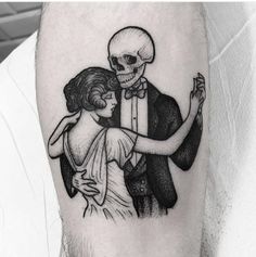 a man with a skeleton tattoo on his arm holding a woman's head and wearing a tuxedo