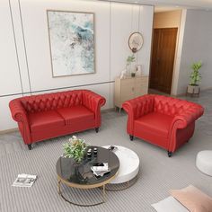 two red couches and a coffee table in a living room with white carpeting