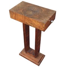 a small wooden table with one leg on it