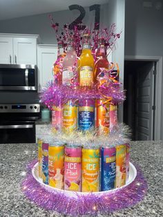 a cake made out of cans and tinsels on top of a kitchen counter