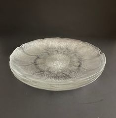 a clear glass bowl sitting on top of a table