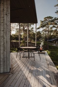 a table and chairs on a wooden deck