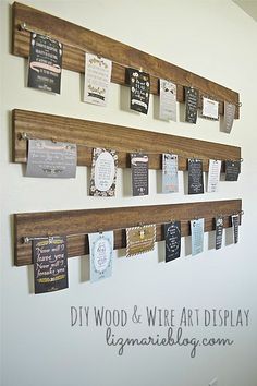 a group of pictures hanging on a wall with some words attached to it and the word diy wood & wire art display