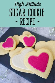 heart shaped sugar cookie recipe on a black plate