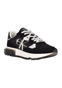 Classic and essential, the Calvin Klein Magalee sneaker is an elevated take on the retro lace up sneaker. Its detailed with color blocking and pops of color on the sole. The Calvin Klein Jeans logo is features on the side. | Calvin Klein Women's Magalee Casual Sneakers, Black, 8M