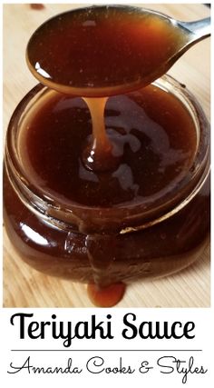 a spoon full of teriyaki sauce sitting on top of a wooden table