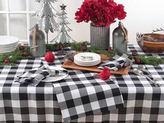 a black and white checkered table cloth with red poinsettis