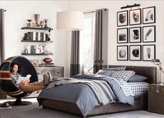 a bedroom with a bed, chair and pictures on the wall above it is shown