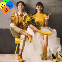 a man and woman sitting on a yellow chair with flowers in their hands, one holding a flower bouquet