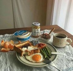 a breakfast plate with eggs, toast and asparagus