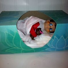 an image of a doll in a cat bed made out of a cardboard box with the caption elf on the shelf ideas bundles of fun