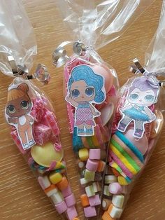 three littlest doll candy sticks in plastic bags on a table next to each other