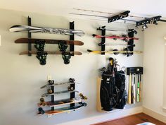 there are many snowboards and skis hanging on the wall