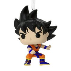 a dragon ball figure is hanging from a keychain on a white background with an orange and blue outfit