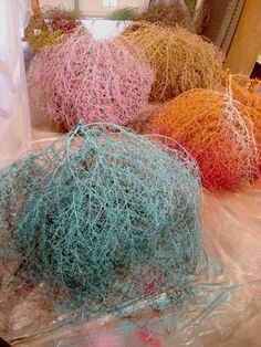 three balls of yarn sitting on top of plastic