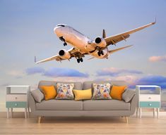 an airplane taking off into the sky above a couch