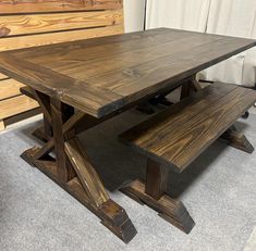 a wooden table with two benches next to it