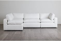 a white couch sitting on top of a hard wood floor