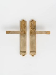 two gold door handles on a white background