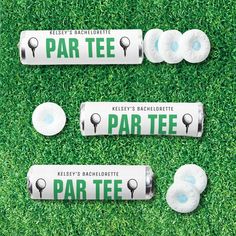 three rolls of par tees sitting on top of green grass