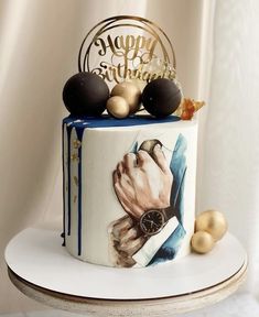 there is a cake that has been decorated with gold and black decorations on it's side