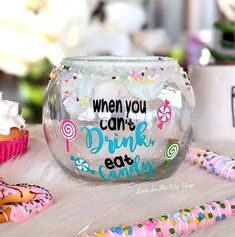 there is a glass bowl with some candy in it and the words, when you can't drink donuts eat candy