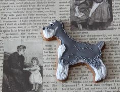 a cookie shaped like a dog on top of a piece of paper with an image of a woman and child