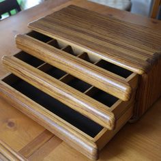 three wooden drawers are stacked on top of each other