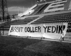 a banner that reads basit coller yedik in front of an empty bleachers