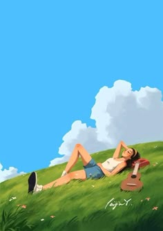 a woman laying on top of a lush green field