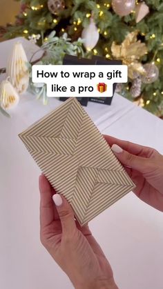 someone is holding up a gift box with the words how to wrap a gift like a pro