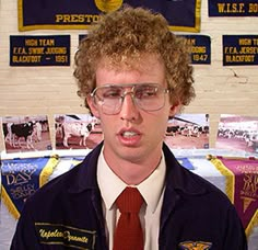 a young man wearing glasses and a red tie is making a funny face at the camera