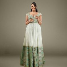 This magnificent piece is one of the true examples of traditional elegance meeting modern charm. The rich blend of traditional motifs and modern design elements makes this dress a versatile piece, suitable for special occasions like weddings, cultural ceremonies, or festive celebrations. Material Cotton Menen Thread Estimated delivery : 2 weeks Contact WhatsApp +1(304)-306-2784Email: contact@ethiopian.store Holiday Wedding Dress, Ethiopian Traditional Dress, Ethiopian Dress, Habesha Kemis, Traditional Motifs, Dresses Xxl, Traditional Dress, Holiday Wedding, Wedding Dresses Simple