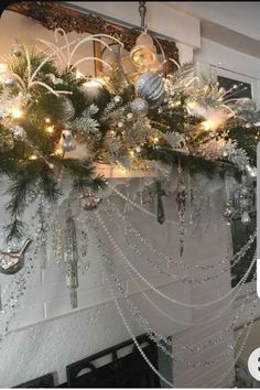 a fireplace decorated for christmas with ornaments and lights