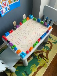 a child's play table with legos on it