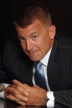 a man in a suit and tie sitting at a table