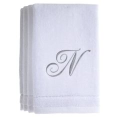 three white towels with the letter m on them