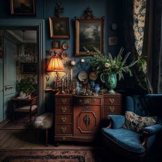 a blue chair sitting next to a wooden dresser in a room with pictures on the wall