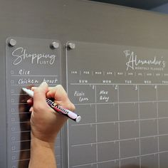 a person writing on a wall with a marker