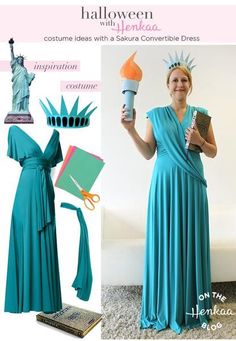 a woman in a blue dress is holding an object and standing next to the statue of liberty