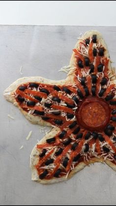 a star shaped pizza sitting on top of a table