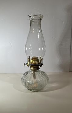 an old fashioned glass oil lamp on a table