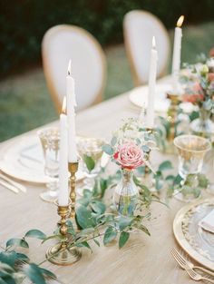 the table is set with candles and flowers