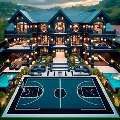 an aerial view of a large house with a basketball court in the middle of it