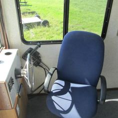 an office chair sitting in front of a window