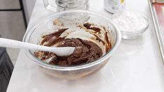 a bowl filled with ice cream sitting on top of a counter next to other ingredients