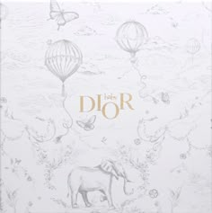 an elephant and hot air balloons on a white background with the words dior written in gold