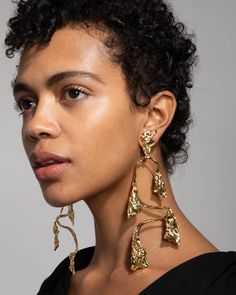 "Details Inspired by mobiles and their play on negative space and balance. These decadent oversized clip earrings are sculpted from 14k gold plated metalwork with crumpled Byzantine inspired texture that reflect light from every angle. 14k gold plated brass 30g, medium weight UPC: 889519127640 Measurements 6\" length x 2.25\" width Care To clean, gently wipe the surface with a soft cloth. For additional care instructions visit our FAQ page. | Mobile Balance Clip Earrings in Gold by Alexis Bittar Alexis Bittar Earrings, Clip Earring, Stacked Bangles, Earrings In Gold, Costume Shop, Alexis Bittar, Earring Sale, Brass Jewelry, Brass Earrings