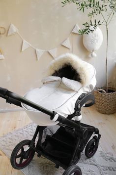 a baby stroller with a fur lined hood