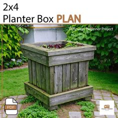 a wooden planter box sitting in the grass